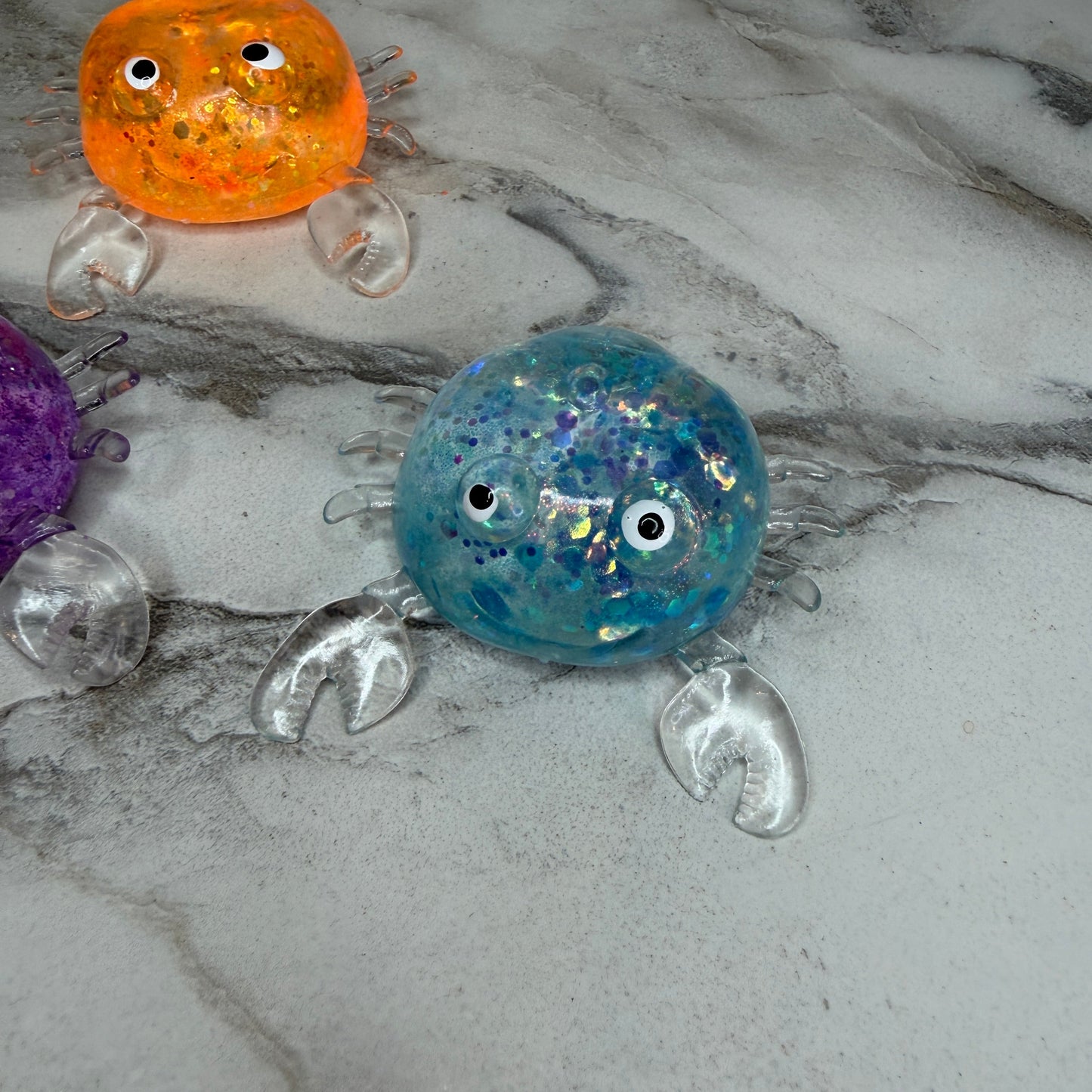 Squishy Toy - Glitter Crab-on hand