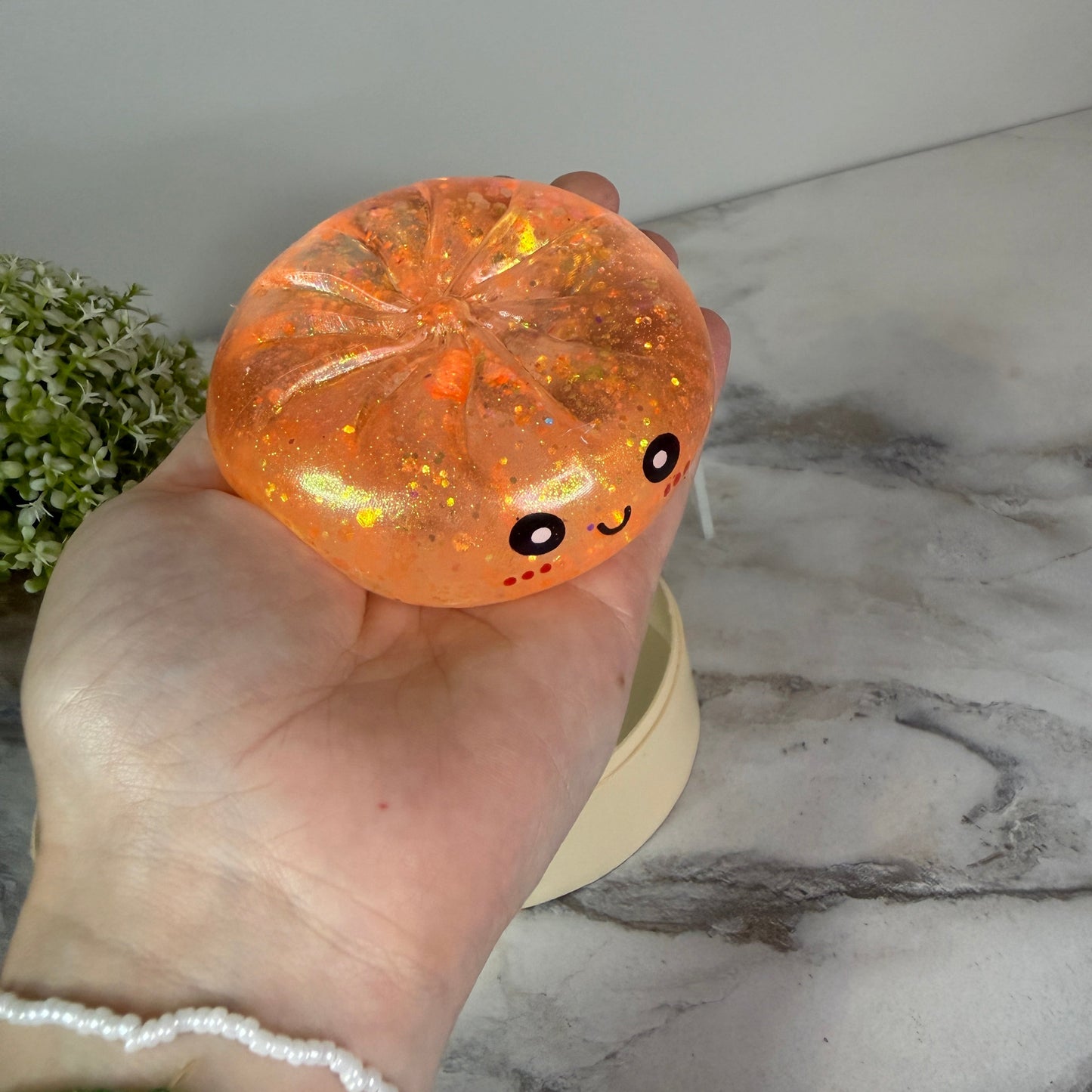 Squishy Toy - Viral Dumpling, Slow Rise Glitter - Light Orange-on hand